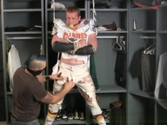 Tall redheaded football player bound gagged and stripped.