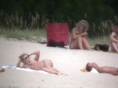 Nude couples are relaxing on a nudist beach here