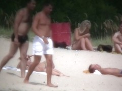Busty blonde nude beach MILF spied on by a voyeur