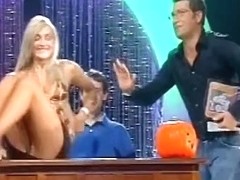 A stupid yet sexy blonde whore poorly dances on a live television show