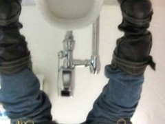 Girl in jeans and boots pissing on toilet shot from behind