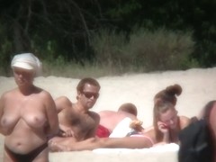 Huge boobed sexy ladies lie on the beach and relaxing