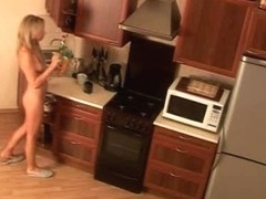 Blonde chick naked in the kitchen