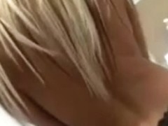 Busty blonde plays with her tits in the bathroom