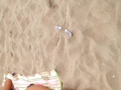Black thong laying down on beach