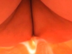 Amateur upskirt video shows a girl in a seductive orange dress.