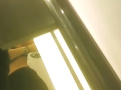 Girl in fitting room posing in new top before mirror