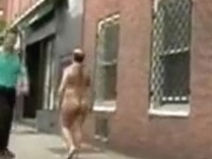 Hairy naked man masturbates on a city sidewalk