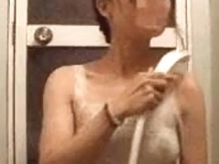 Asian wife showers her small titties in thin white top