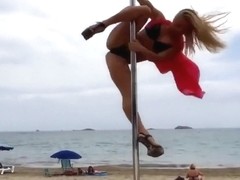 Blonde lass doing her pole dancing show