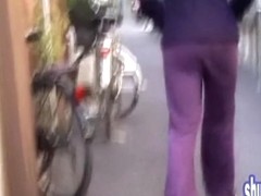 Asian babe gets her pants pulled by a street sharker.