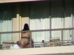 Voyeur tapes a couple having sex on the balcony of their apartment