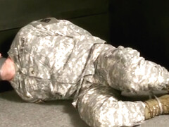 Soldier hogtied tape gagged and struggling.