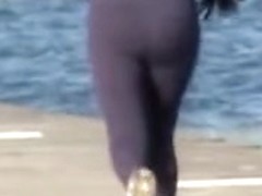 Candid ass milf is running along the golden beach 08i
