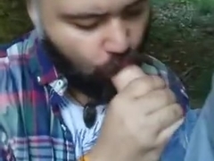 Bearded bear suicking cock in the woods