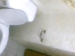 One girl pissing on toilet after another on the spy cam