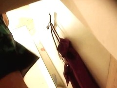 A girl without underwear is trying on some nice dresses in this voyeur changing room video