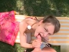 She lays on the grass as she gets her mouth fucked