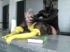 Kinky dude in a latex suit fucks his plump maid slave