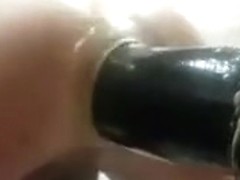 A kneeling giant dildo fucking