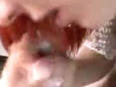 Close-up blowjob performed by a beautiful redhead