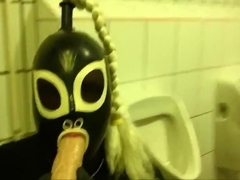 Rubberdoll Monique - Blowjob training in a public toilet