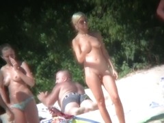 Blonde sexy completely nude woman standing on a beach porno