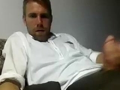 Charming guy is jerking off in the apartment and filming himself on computer webcam