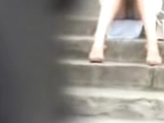 Girl sitting on the stairs and showing panty upskirt