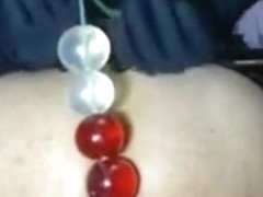 Chick Puts Some Big Beads In Her Butt