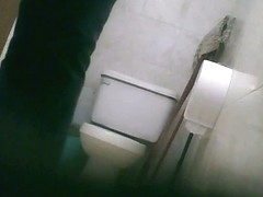 Big booty brunette babe pissing in the toilet