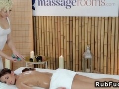 Masseuse rubs babe with massage tool