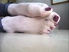 Sheer pale stockinged feet