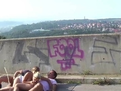 Incredible blonde woman is having a threesome in a public place, with two horny strangers