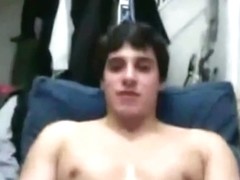 Straight hockey player giving a webcam show with team friends looking on