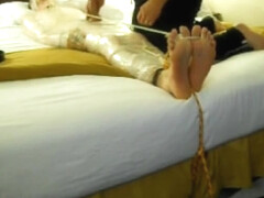 Tickled wrapped tied on bed