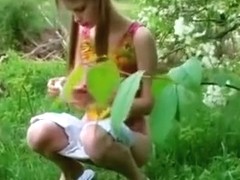 Petite pigtailed teen goes pee in the woods