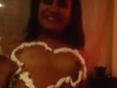 Naked amateur girl draws a heart on her chest with whipped cream