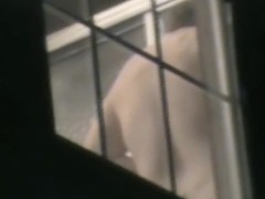 Naked amateur back through the window voyeured on cam