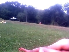 Girl in tiniest bikini getting sun tanned in the field PICT0011