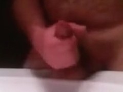 Slutty Greek bear wanks off in the bathroom