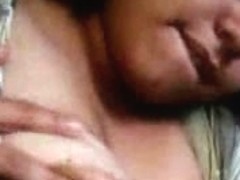 Indian girl with huge tits sucking on a small stick