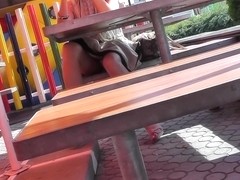 Sexy sitting upskirt in a street cafe