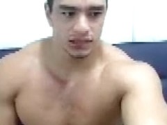 Muscular guy masturbating licks his fingers full of cum