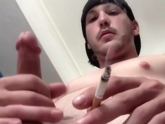 Horny Hunk Smoking And Stroking His Cock