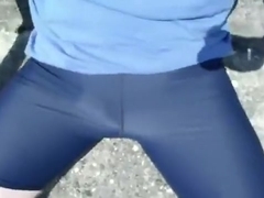 Young cyclist pissing in lycra in the public park